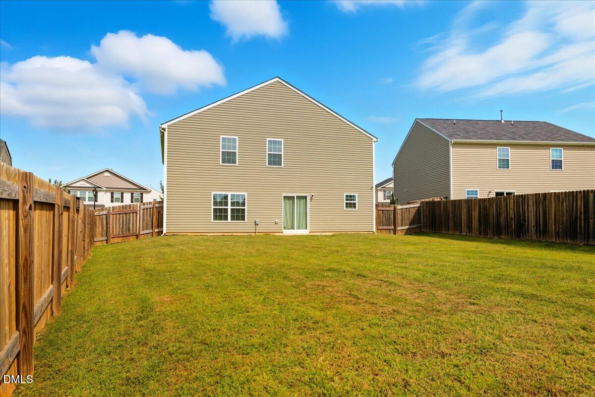 6854 Summerside Drive Whitsett, NC 27377 - Photo 43 of 49 a view of a house with a yard