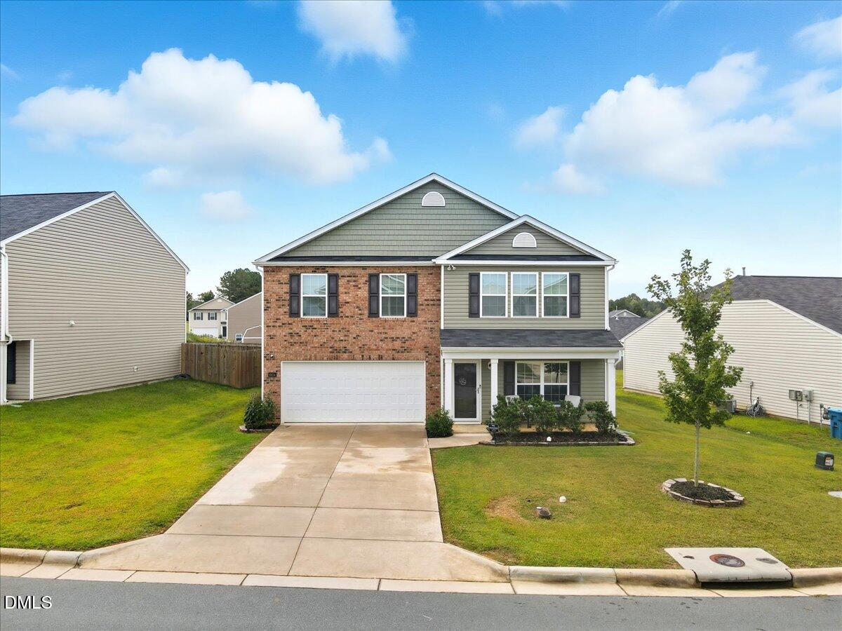 6854 Summerside Drive Whitsett, NC 27377 - Photo 44 of 49 a front view of a house with garden