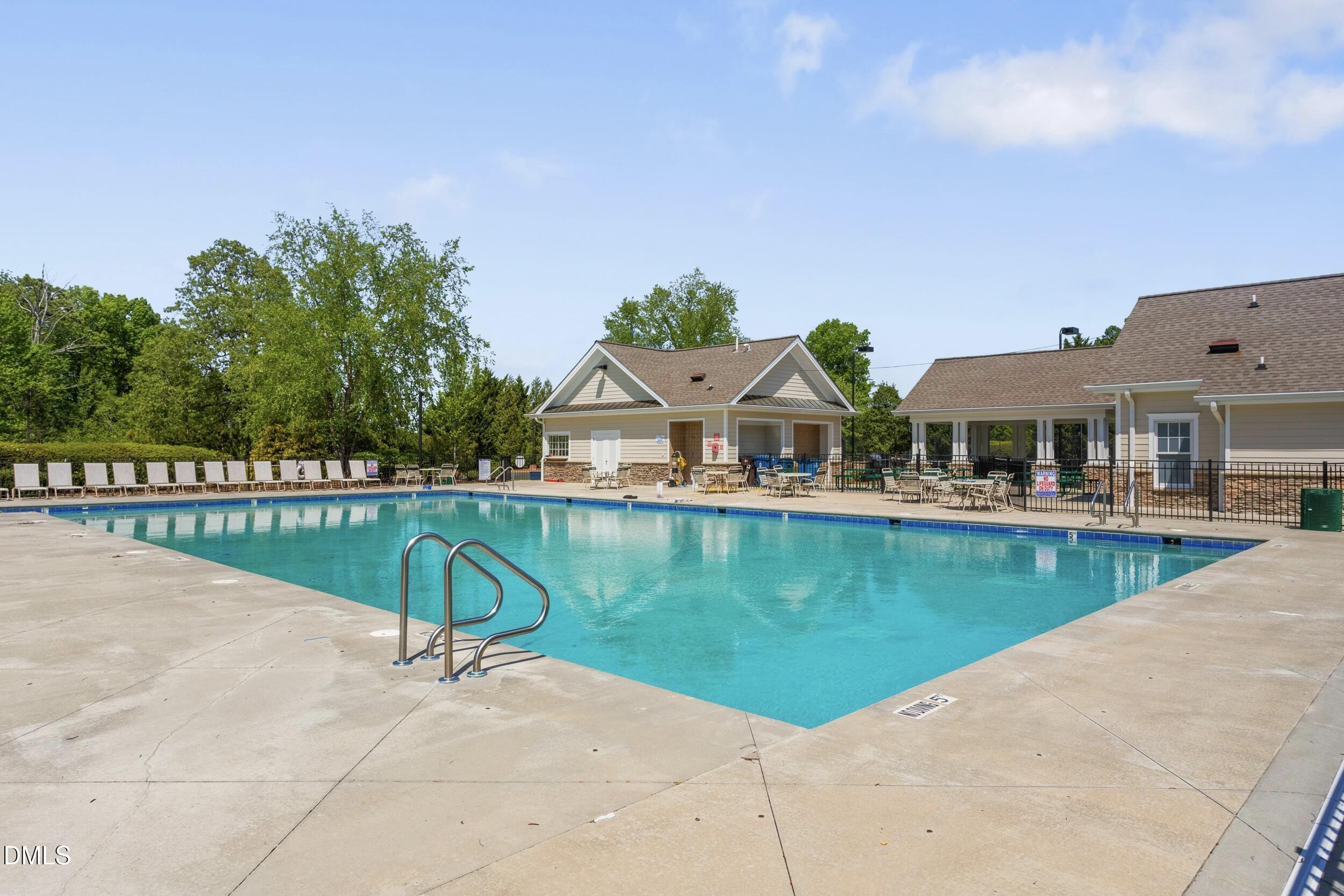 6854 Summerside Drive Whitsett, NC 27377 - Photo 47 of 49 a view of a house with pool and a yard