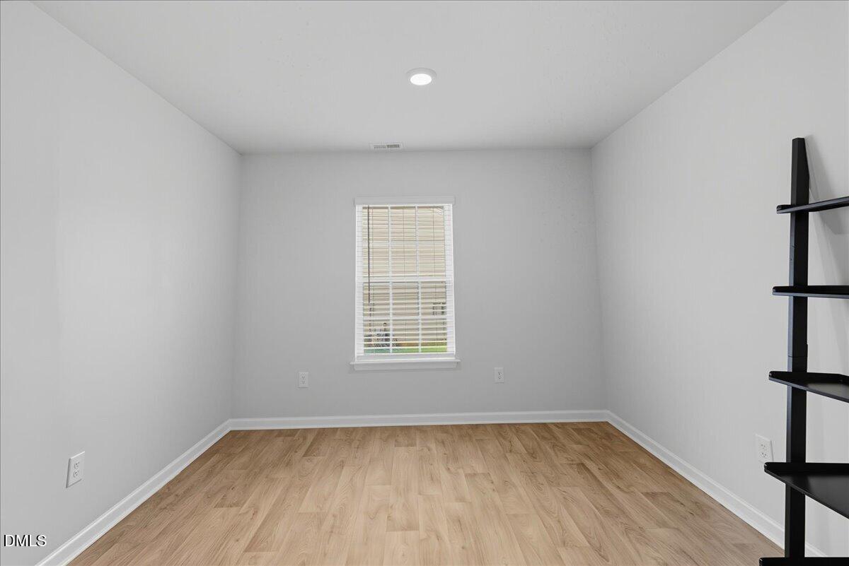 6854 Summerside Drive Whitsett, NC 27377 - Photo 9 of 49 a view of a room with window and hardwood floor
