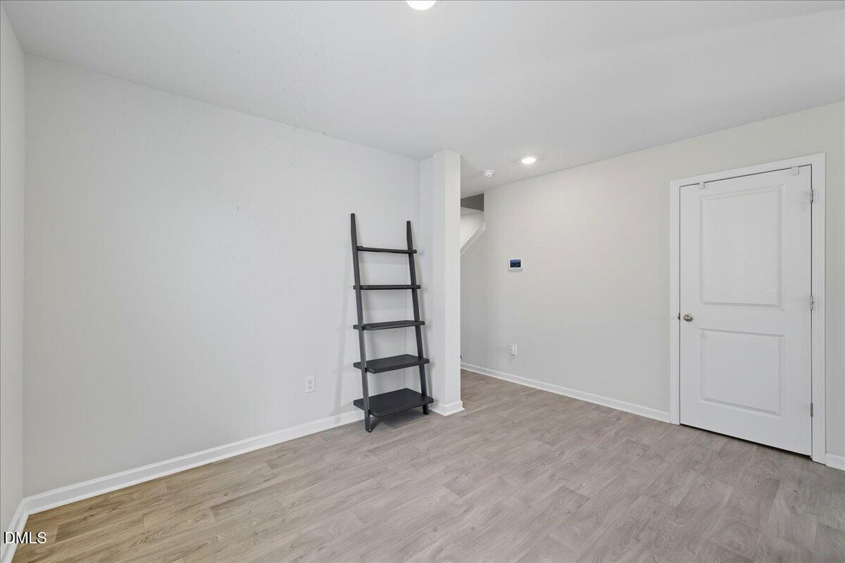 6854 Summerside Drive Whitsett, NC 27377 - Photo 10 of 49 wooden floor in an empty room with a window