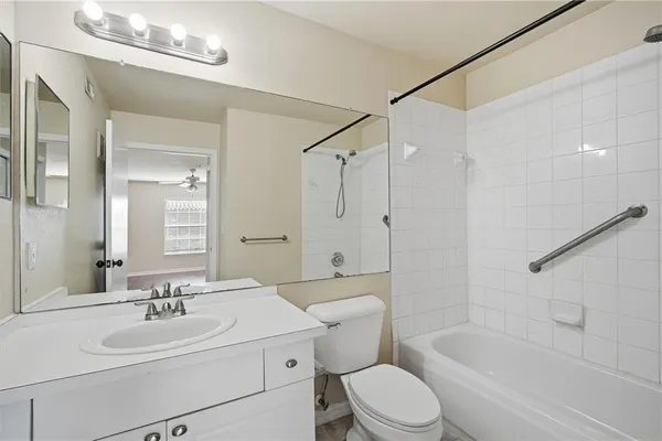 a bathroom with a sink toilet tub and shower