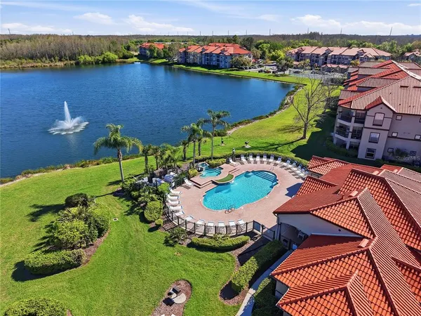 an aerial view of house with yard swimming pool and outdoor seating