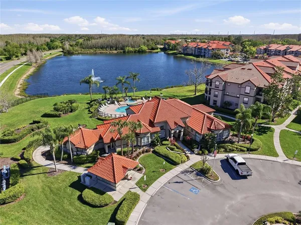 an aerial view of a house with a garden and lake view