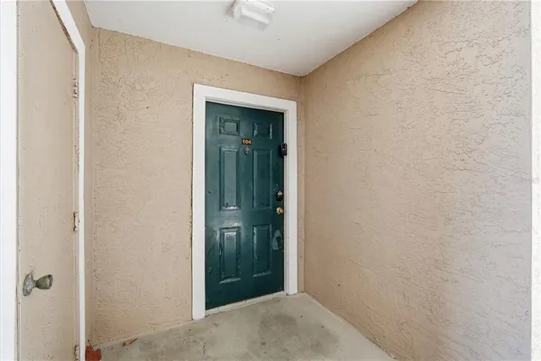 an empty room with wooden floor and window