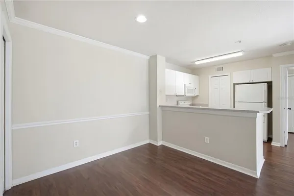 a kitchen with cabinets appliances a sink and a counter top
