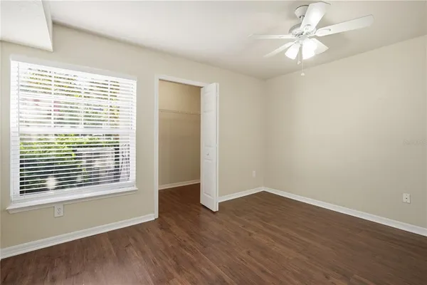 a view of an empty room with wooden floor