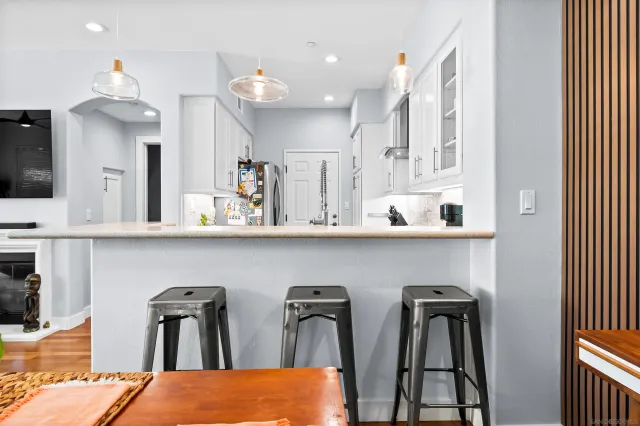 a kitchen with stainless steel appliances granite countertop refrigerator and cabinets