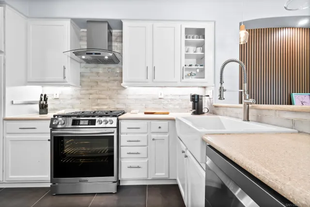 a kitchen with cabinets appliances and a sink