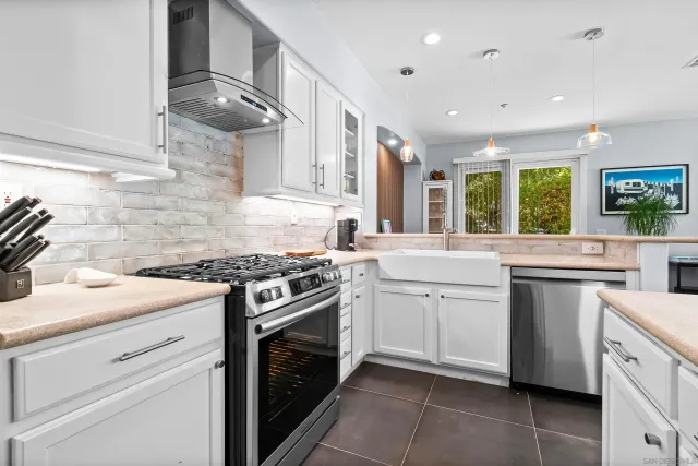 a kitchen with granite countertop cabinets stainless steel appliances and sink