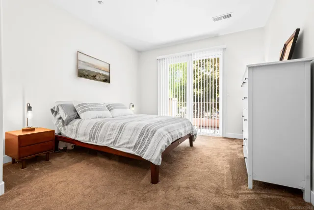 a bedroom with a bed and a large window