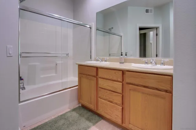 a view of walk in closet with clothes