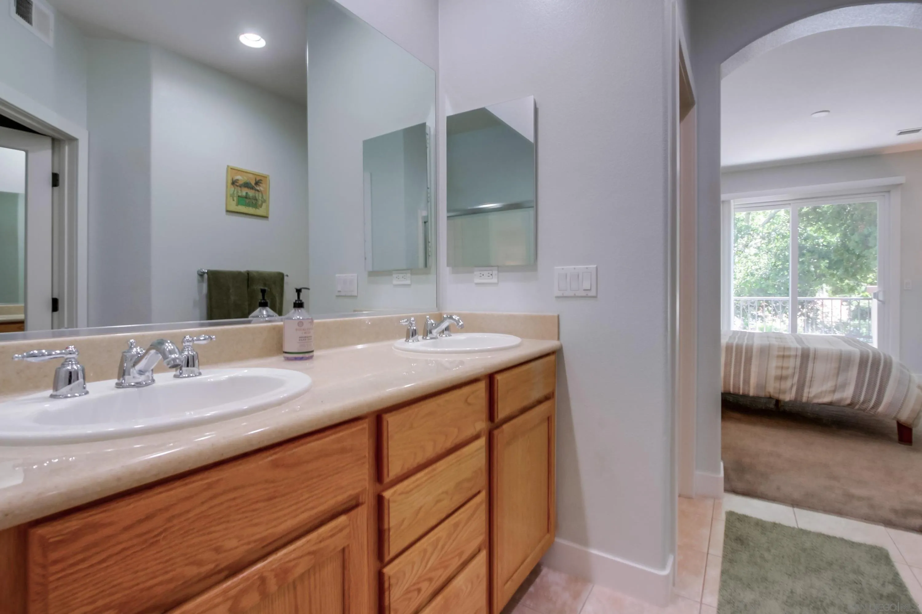 1184 Highbluff Avenue San Marcos, CA 92078 - Photo 31 of 63 a en suite bathroom with a double vanity sink a mirror and a shower