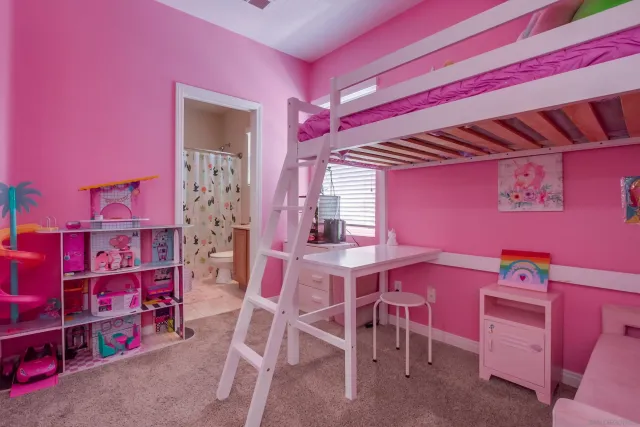 a bathroom with a toilet and a shower curtain