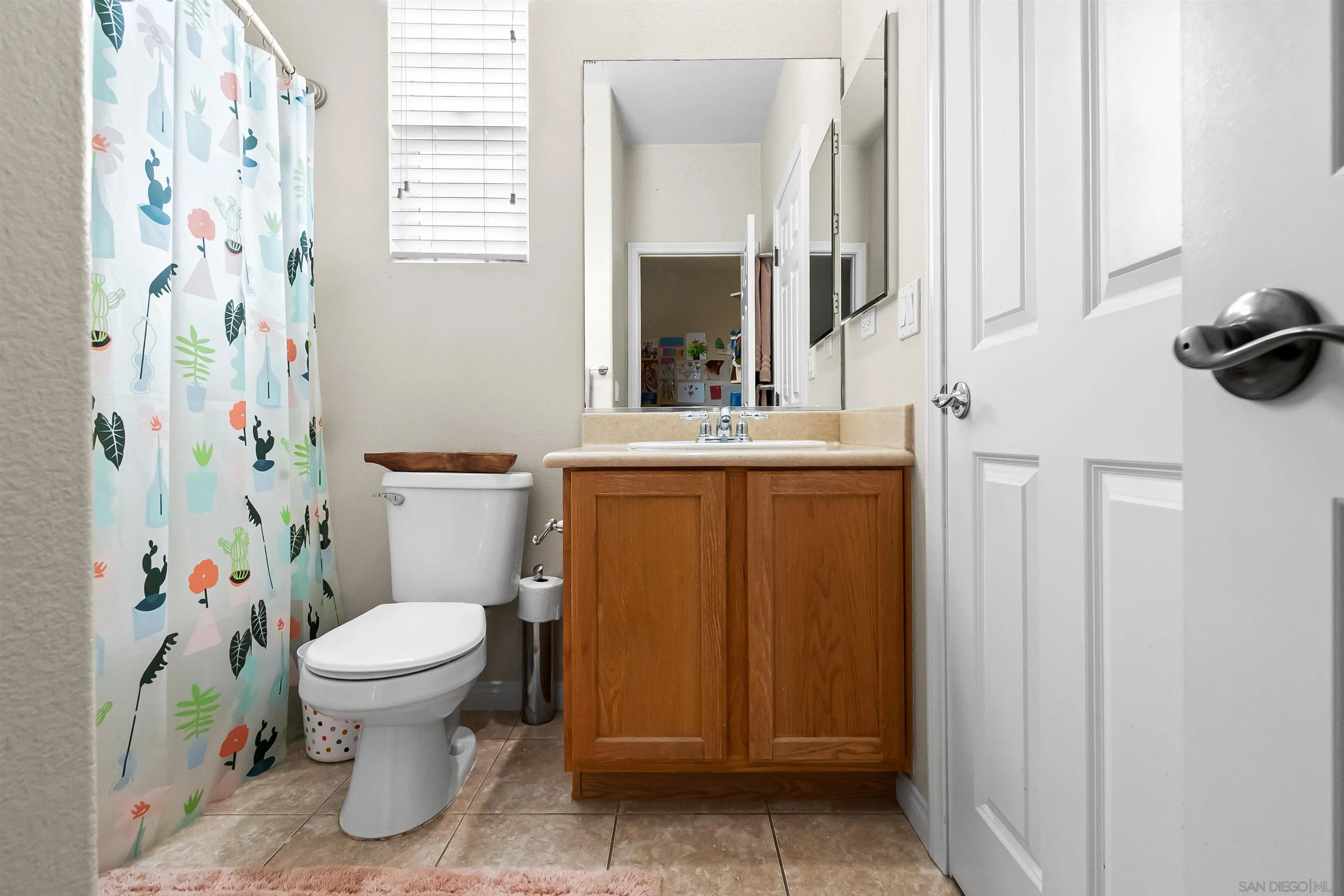 1184 Highbluff Avenue San Marcos, CA 92078 - Photo 39 of 63 a bathroom with a toilet and a shower curtain