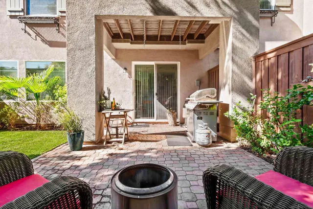 a view of a backyard with plants and tree