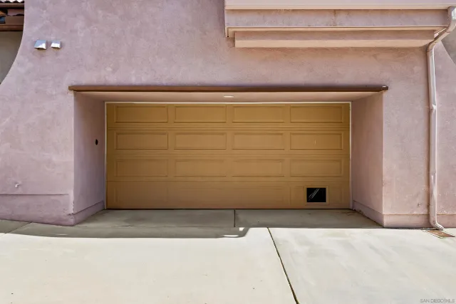 a view of a street with a building and trees in the background