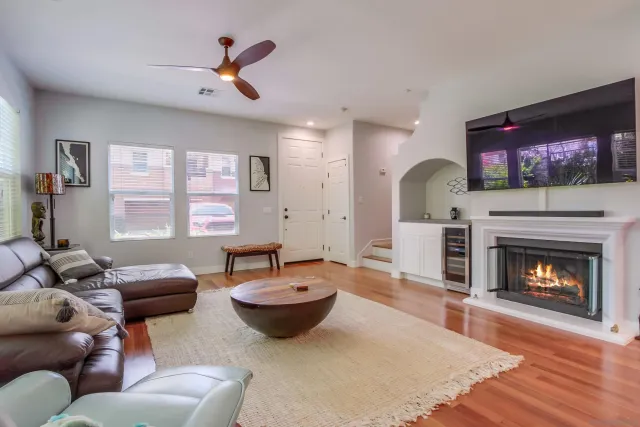 a living room with furniture a fireplace and a flat screen tv