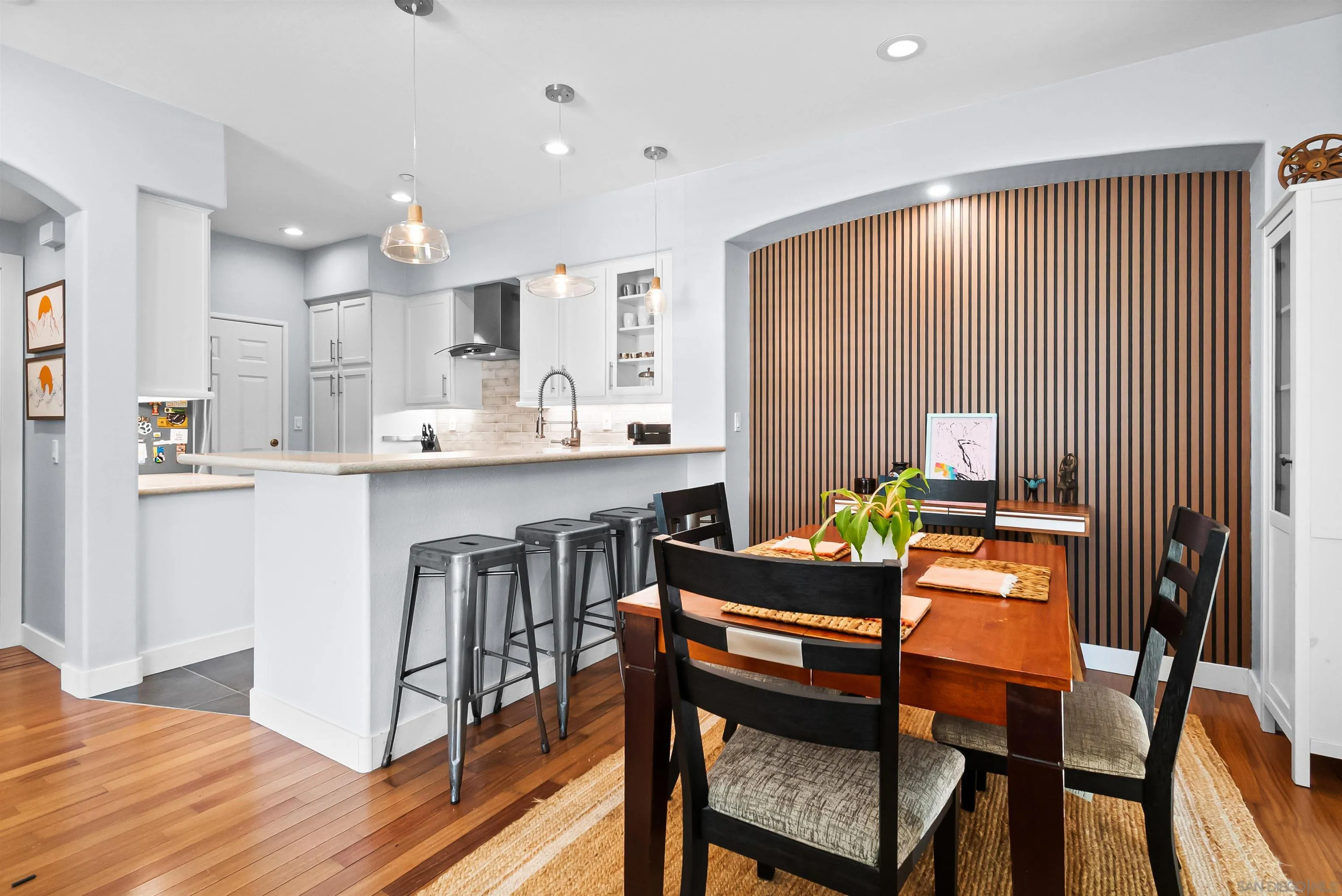 1184 Highbluff Avenue San Marcos, CA 92078 - Photo 10 of 63 a dining room with a table chairs and a kitchen view