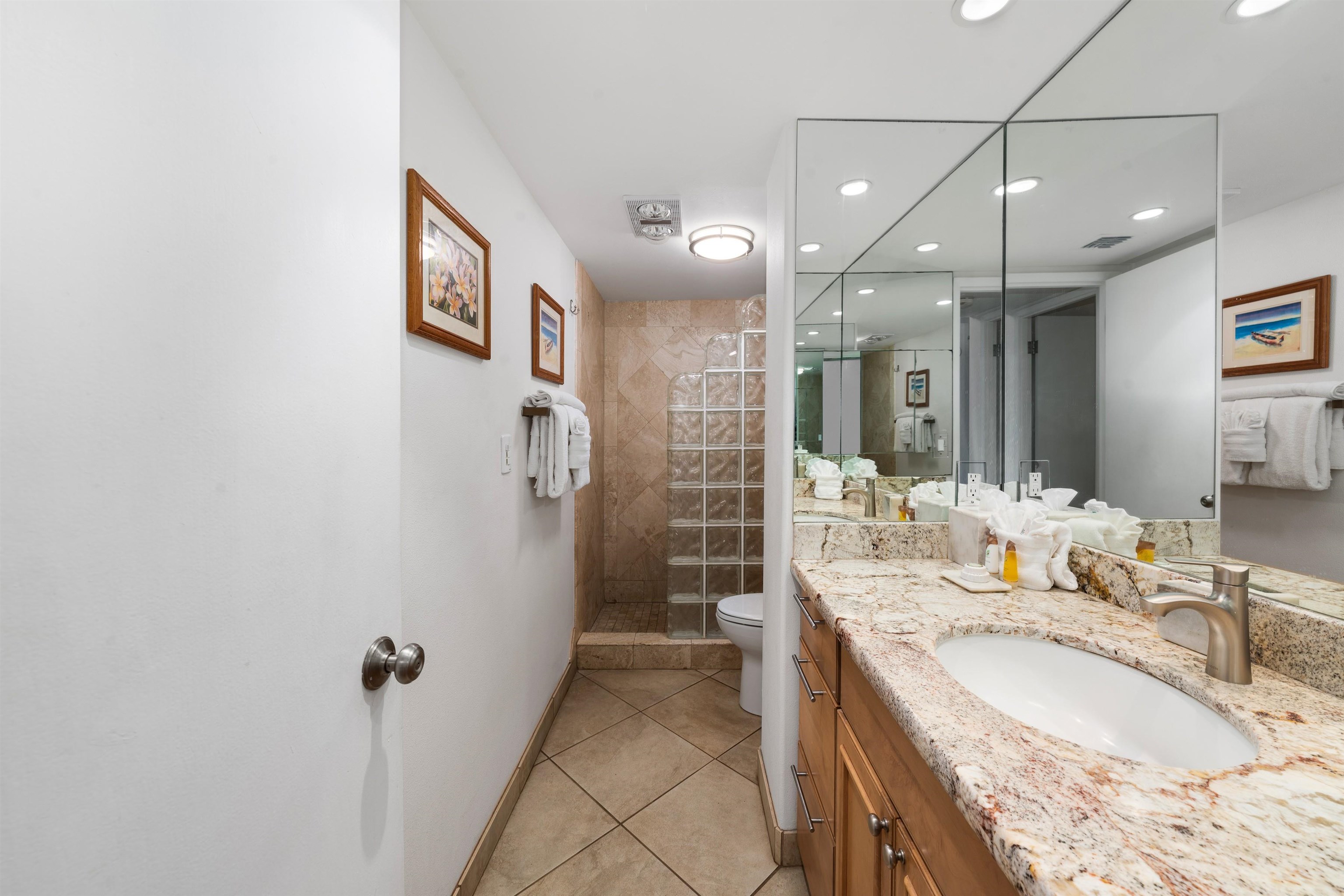 36 South Kihei Road, Unit 603 Kihei, HI 96753 - Photo 11 of 37 a spacious bathroom with a granite countertop sink a mirror a shower and vanity