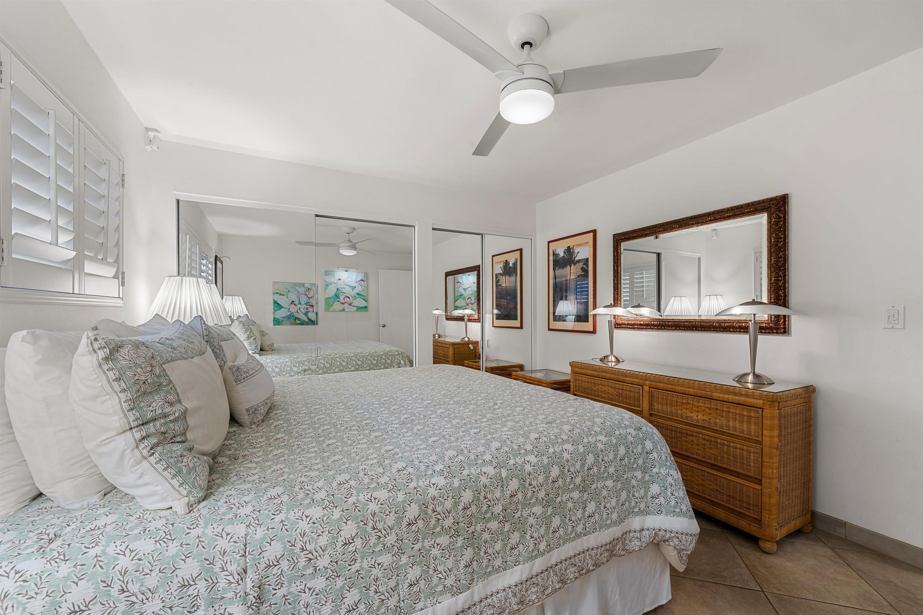 36 South Kihei Road, Unit 603 Kihei, HI 96753 - Photo 13 of 37 a bedroom with a large bed and a chandelier