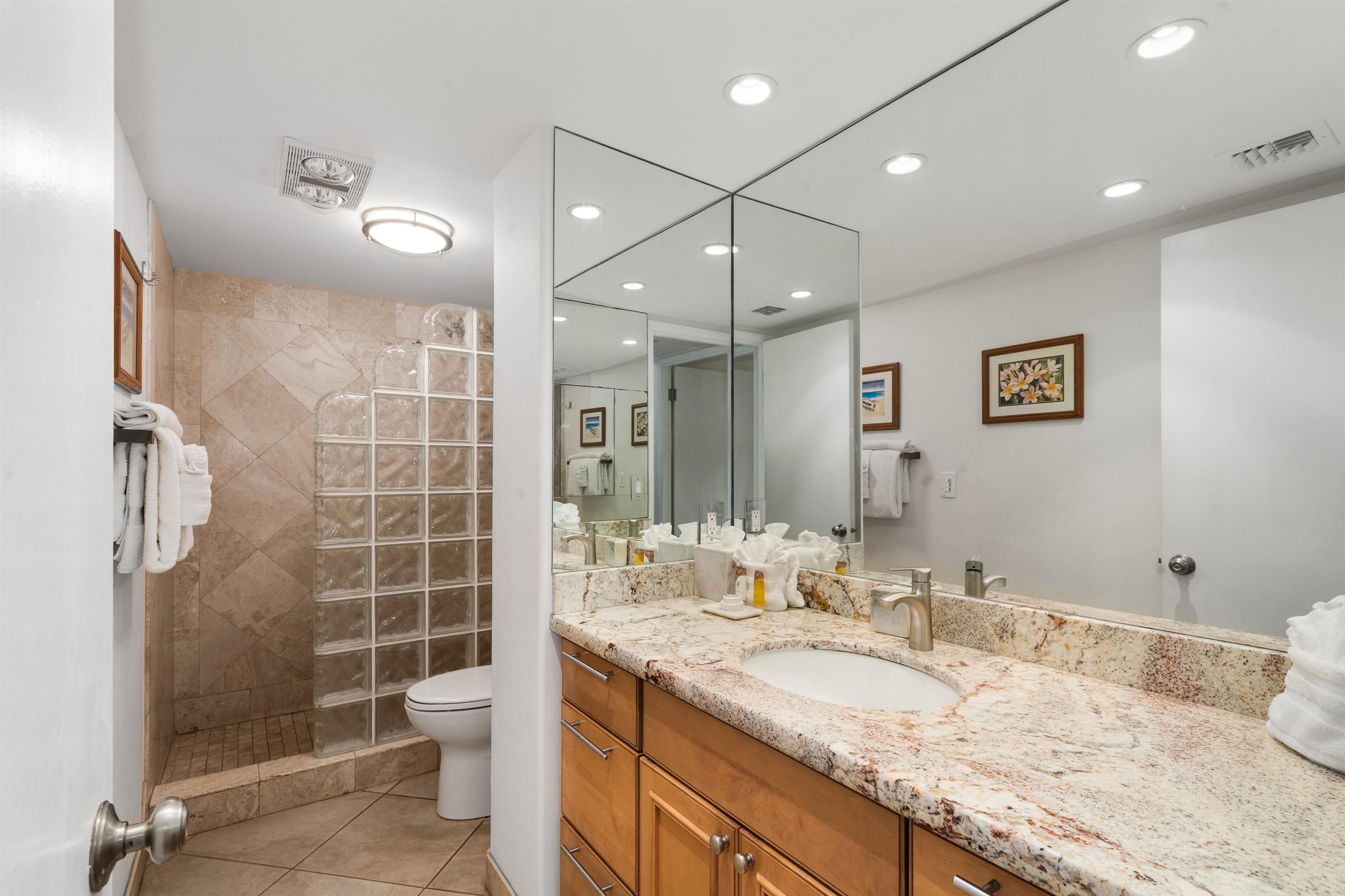 36 South Kihei Road, Unit 603 Kihei, HI 96753 - Photo 10 of 37 a bathroom with a granite countertop sink a shower and a mirror