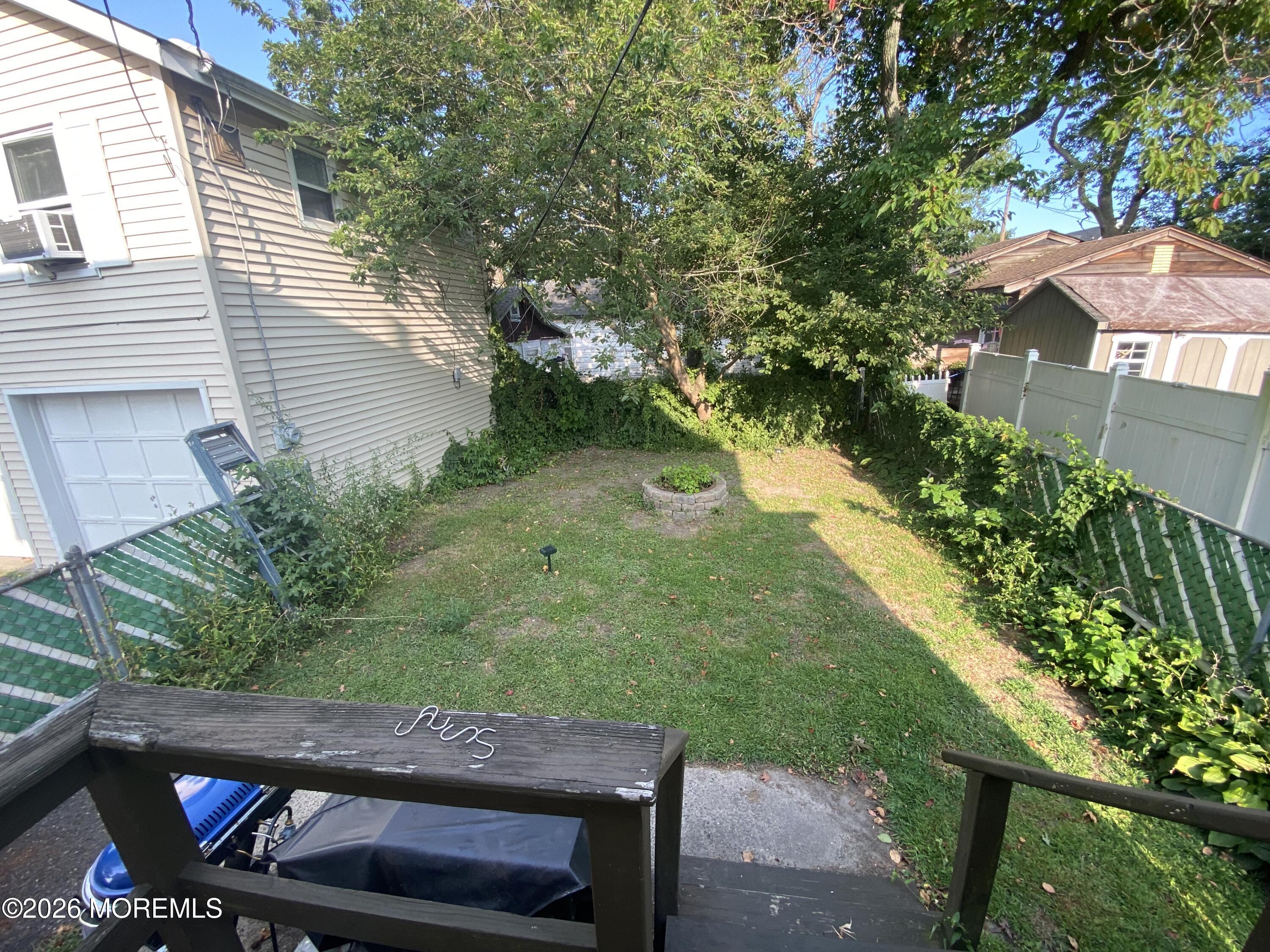 1302 L Street Belmar, NJ 07719 - Photo 11 of 14 a view of backyard with seating area and green space