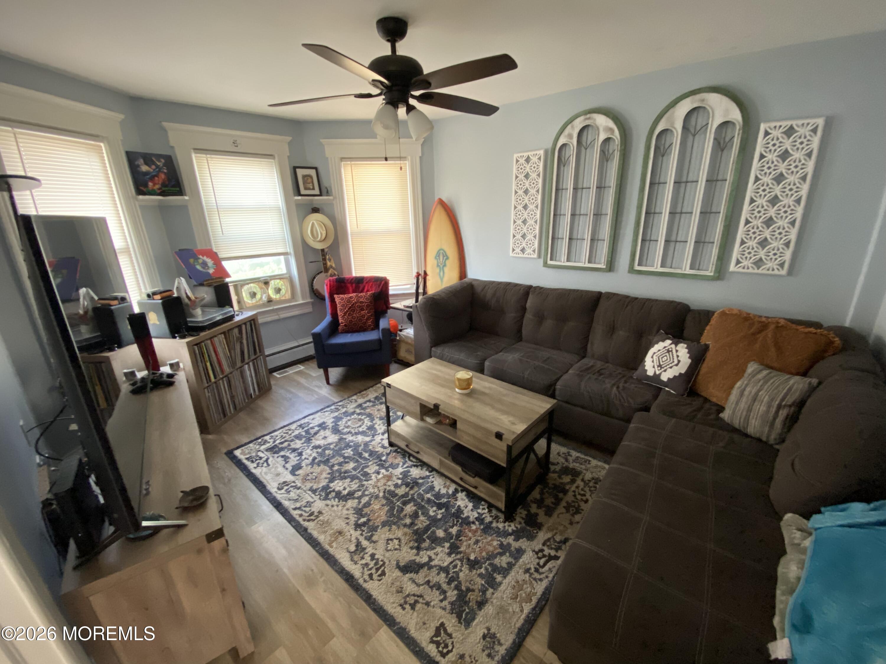 1302 L Street Belmar, NJ 07719 - Photo 4 of 14 a living room with furniture and a flat screen tv