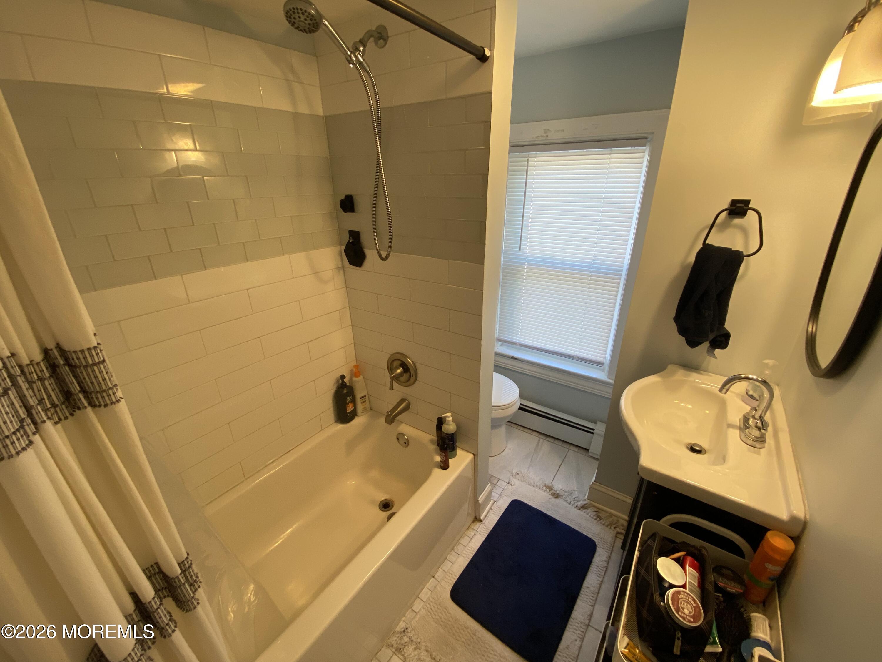 1302 L Street Belmar, NJ 07719 - Photo 9 of 14 a bathroom with a tub sink and toilet