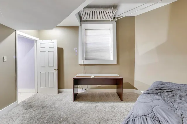 a bedroom with a bed and a table in it