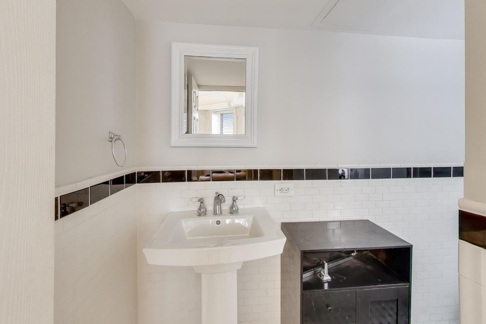 725 West Sheridan Road, Unit 10E Chicago, IL 60613 - Photo 15 of 16 a bathroom with a sink and a mirror