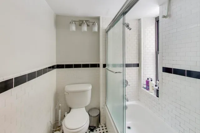 a white toilet sitting next to a bathroom sink