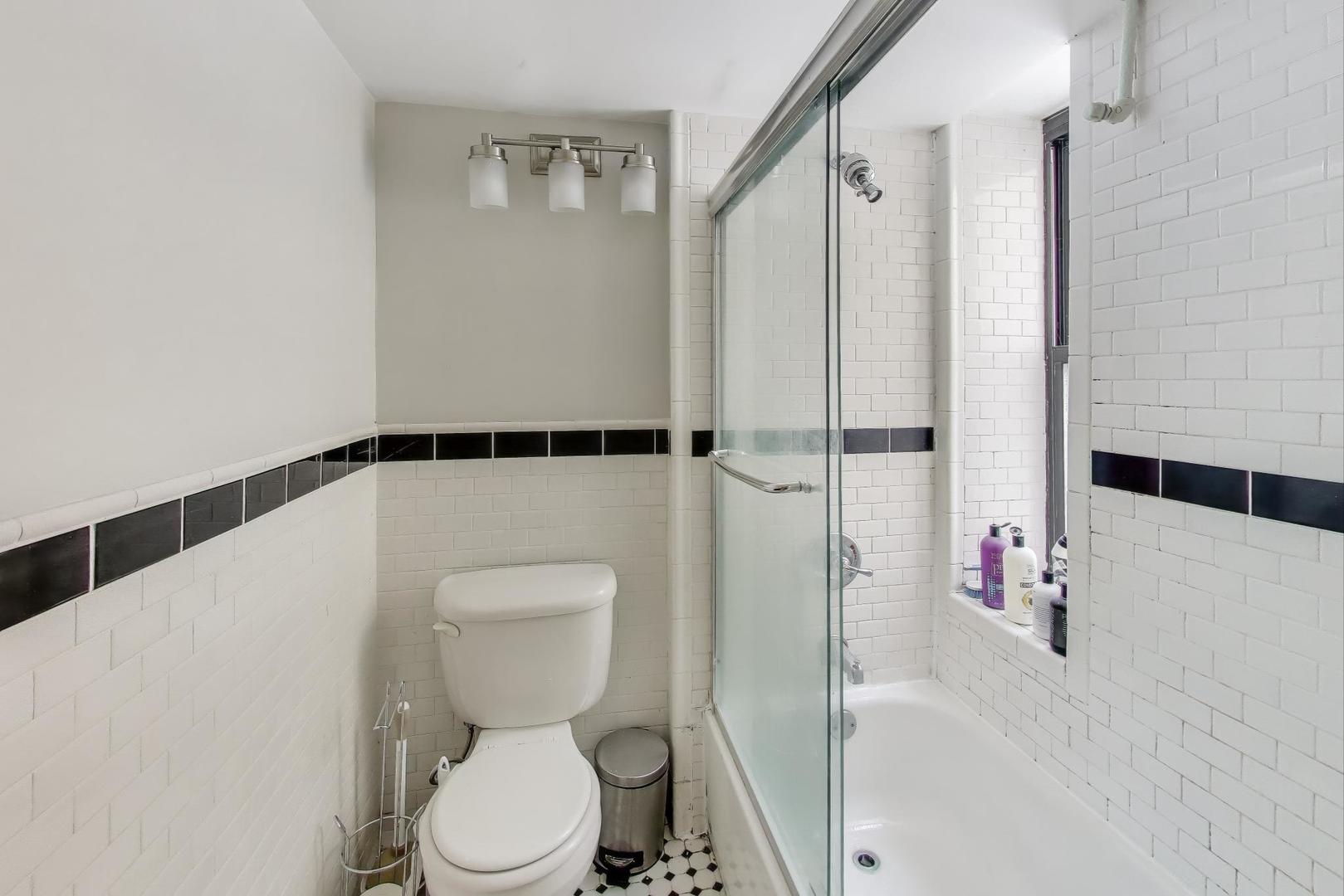 725 West Sheridan Road, Unit 10E Chicago, IL 60613 - Photo 16 of 16 a white toilet sitting next to a bathroom sink