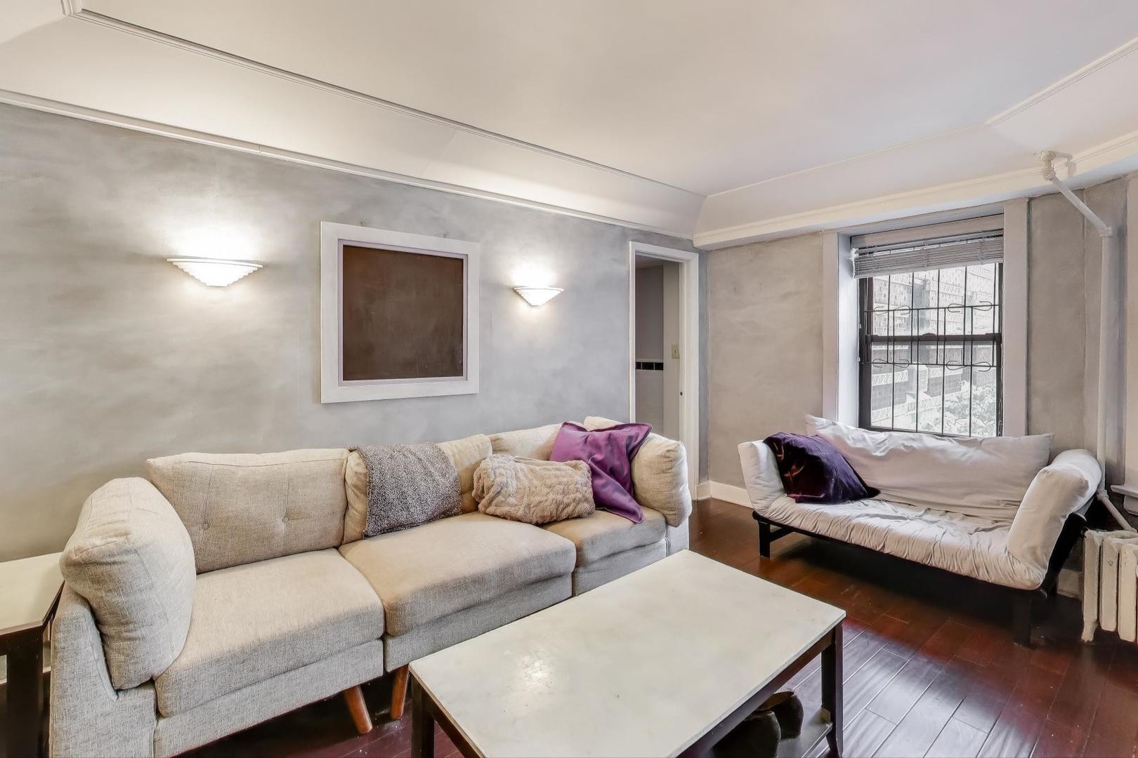 725 West Sheridan Road, Unit 10E Chicago, IL 60613 - Photo 7 of 16 a living room with furniture and a window
