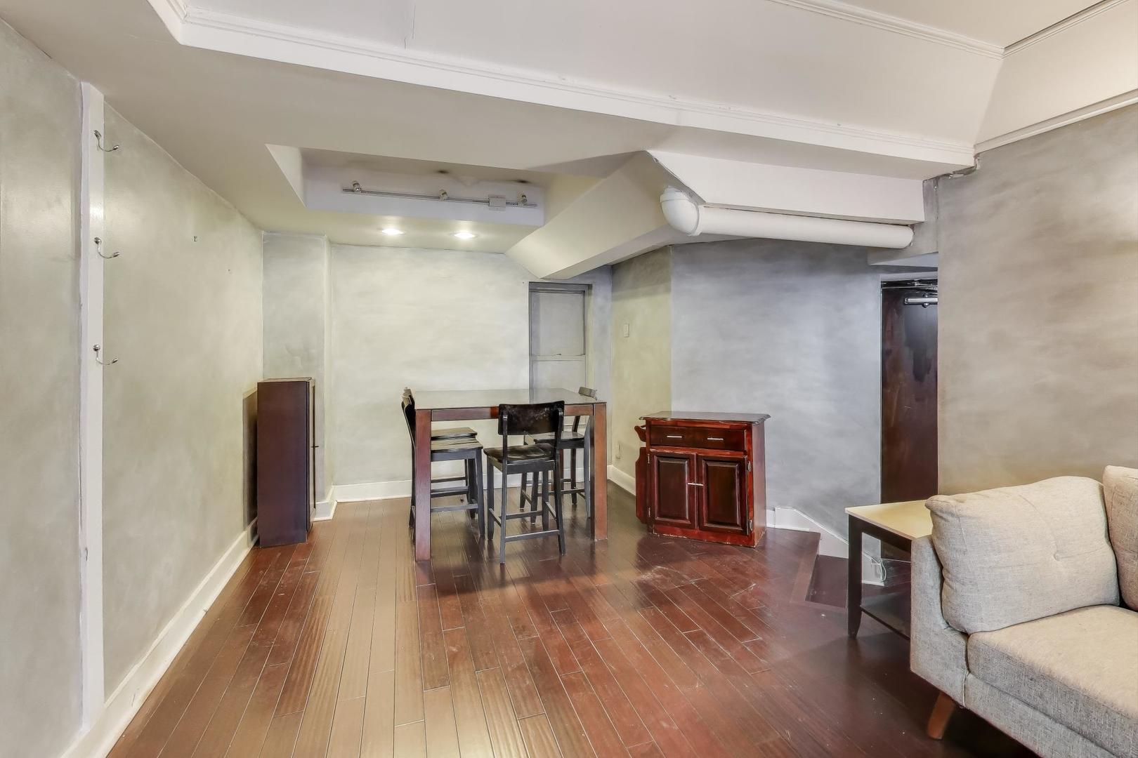 725 West Sheridan Road, Unit 10E Chicago, IL 60613 - Photo 9 of 16 a dining room with furniture and wooden floor