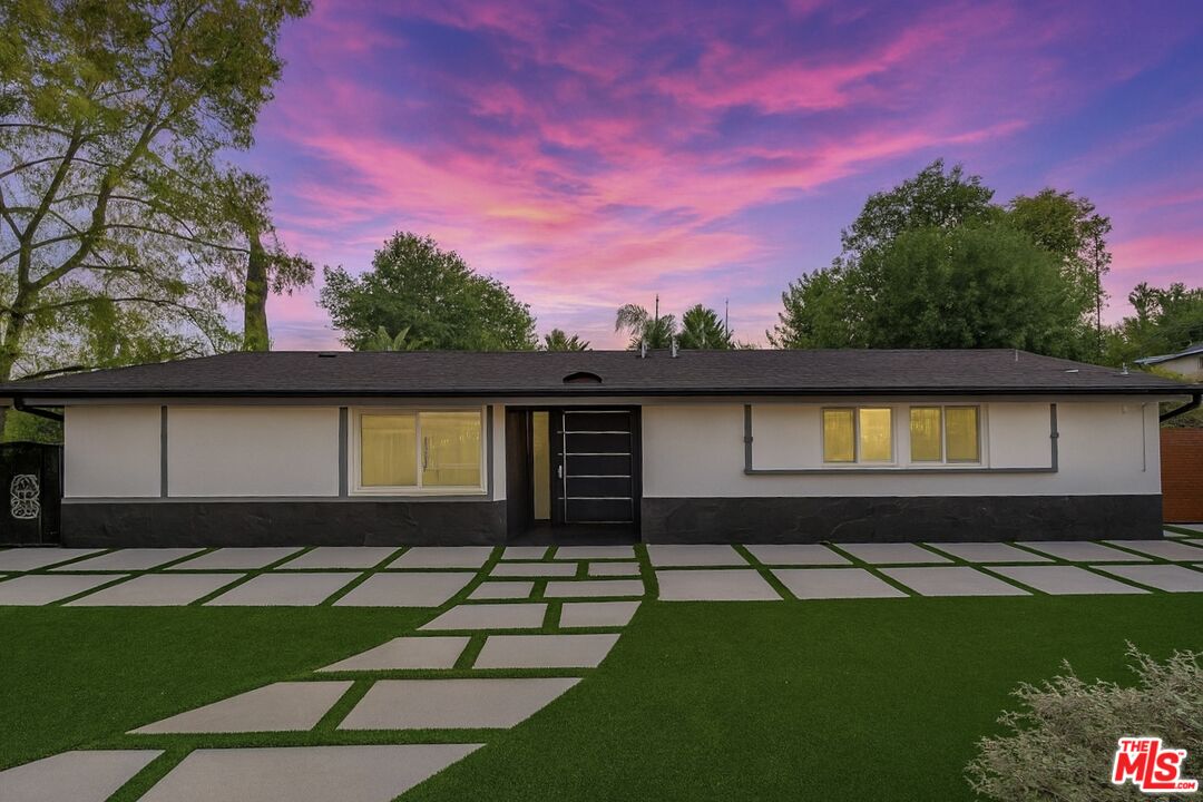 20412 Oxnard Street Woodland Hills, CA 91367 - Photo 1 of 35 a front view of a house with a yard