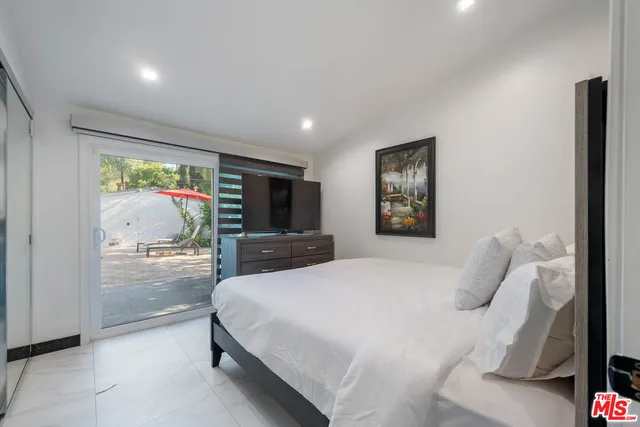 a bedroom with a large bed and a large window