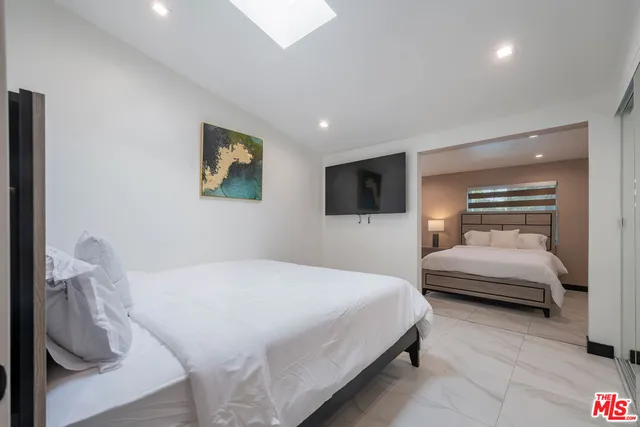 a bedroom with a bed and a couch