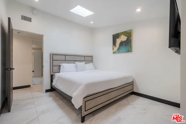 a bed room with a bed and a television