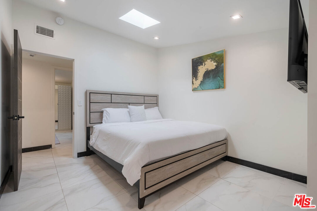 20412 Oxnard Street Woodland Hills, CA 91367 - Photo 15 of 35 a bed room with a bed and a television