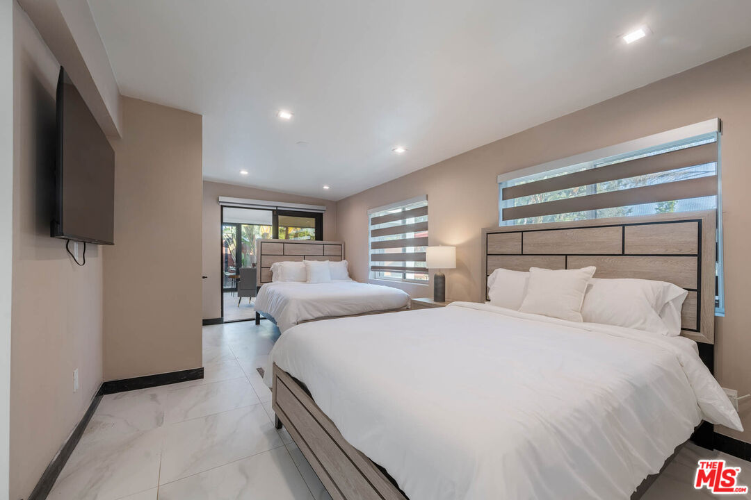 20412 Oxnard Street Woodland Hills, CA 91367 - Photo 16 of 35 a bedroom with a bed and a flat screen tv