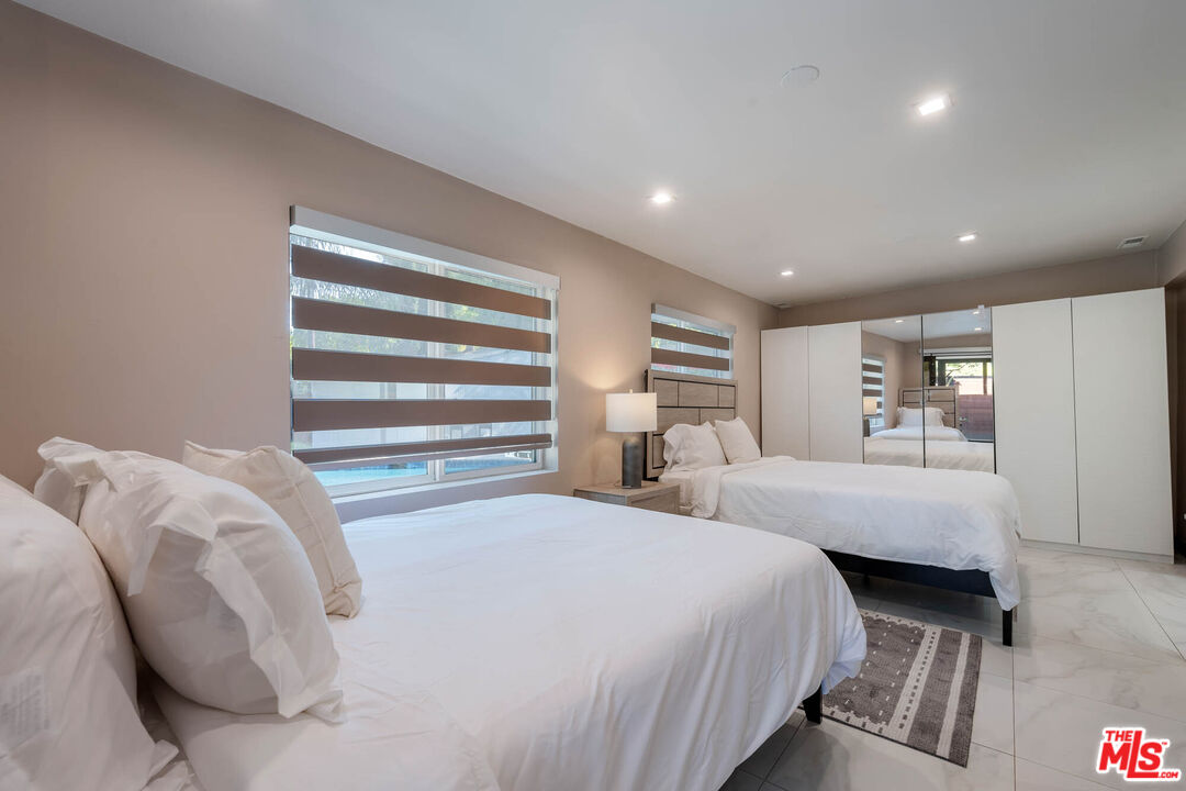 20412 Oxnard Street Woodland Hills, CA 91367 - Photo 18 of 35 a bedroom with a large bed and a couch