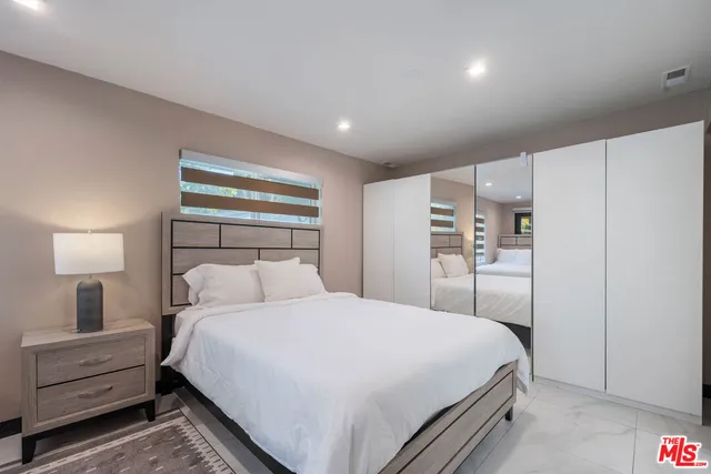 a bedroom with a bed and a lamp