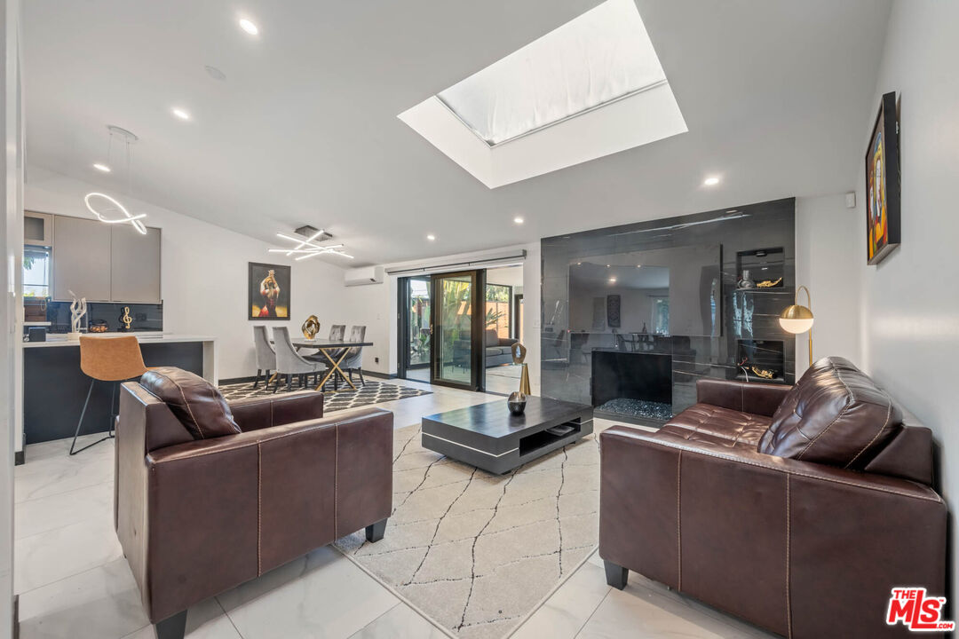 20412 Oxnard Street Woodland Hills, CA 91367 - Photo 22 of 35 a living room with furniture and a large window