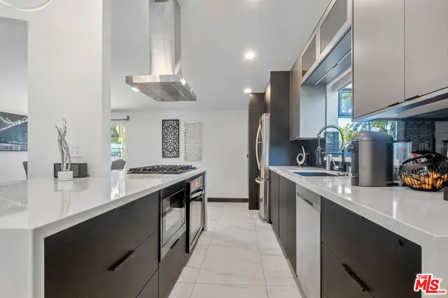 a kitchen with stainless steel appliances a sink stove and cabinets