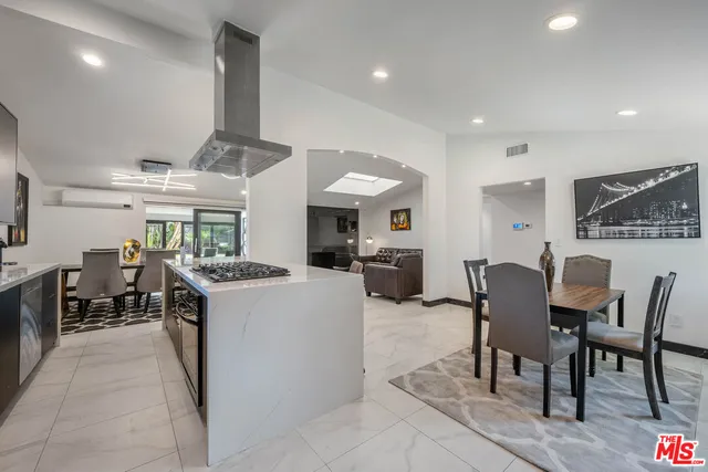 a large kitchen with a table and chairs in it