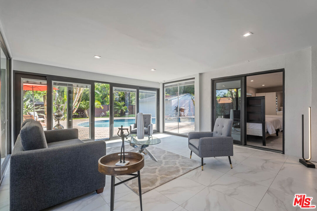 20412 Oxnard Street Woodland Hills, CA 91367 - Photo 28 of 35 a living room with furniture and a large window