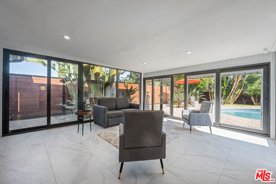 20412 Oxnard Street Woodland Hills, CA 91367 - Photo 29 of 35 a living room with furniture and large windows