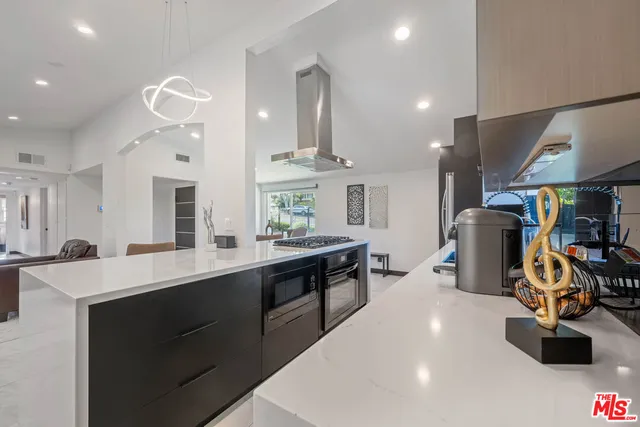 a kitchen with stainless steel appliances a sink stove and refrigerator