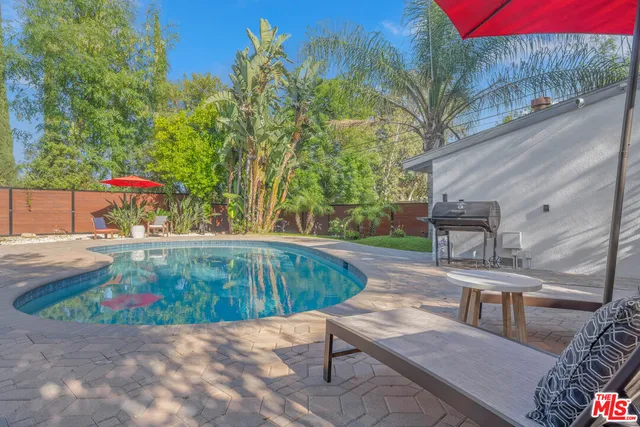 a view of a backyard with sitting area